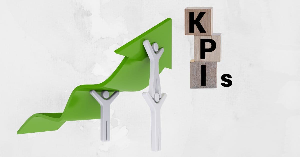 Stick figures holding up a green arrow pointing to building blocks that spell KPI (key performance indicator).