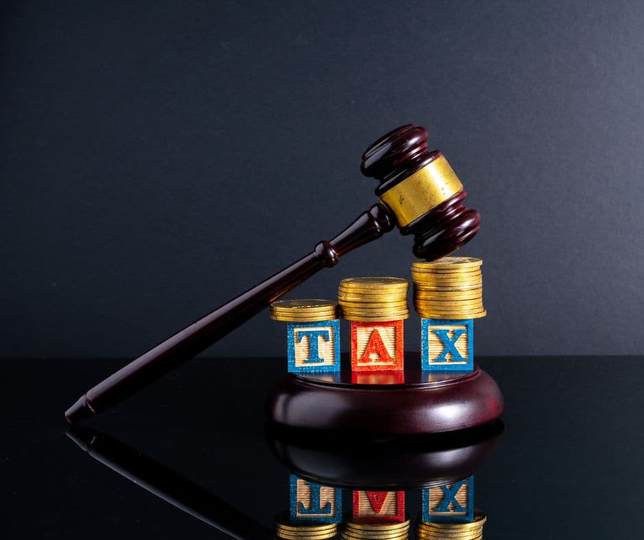 Avoid Tax Penalties Building blocks with the letters TAX and a judges gavel. Avoid Tax Penalties